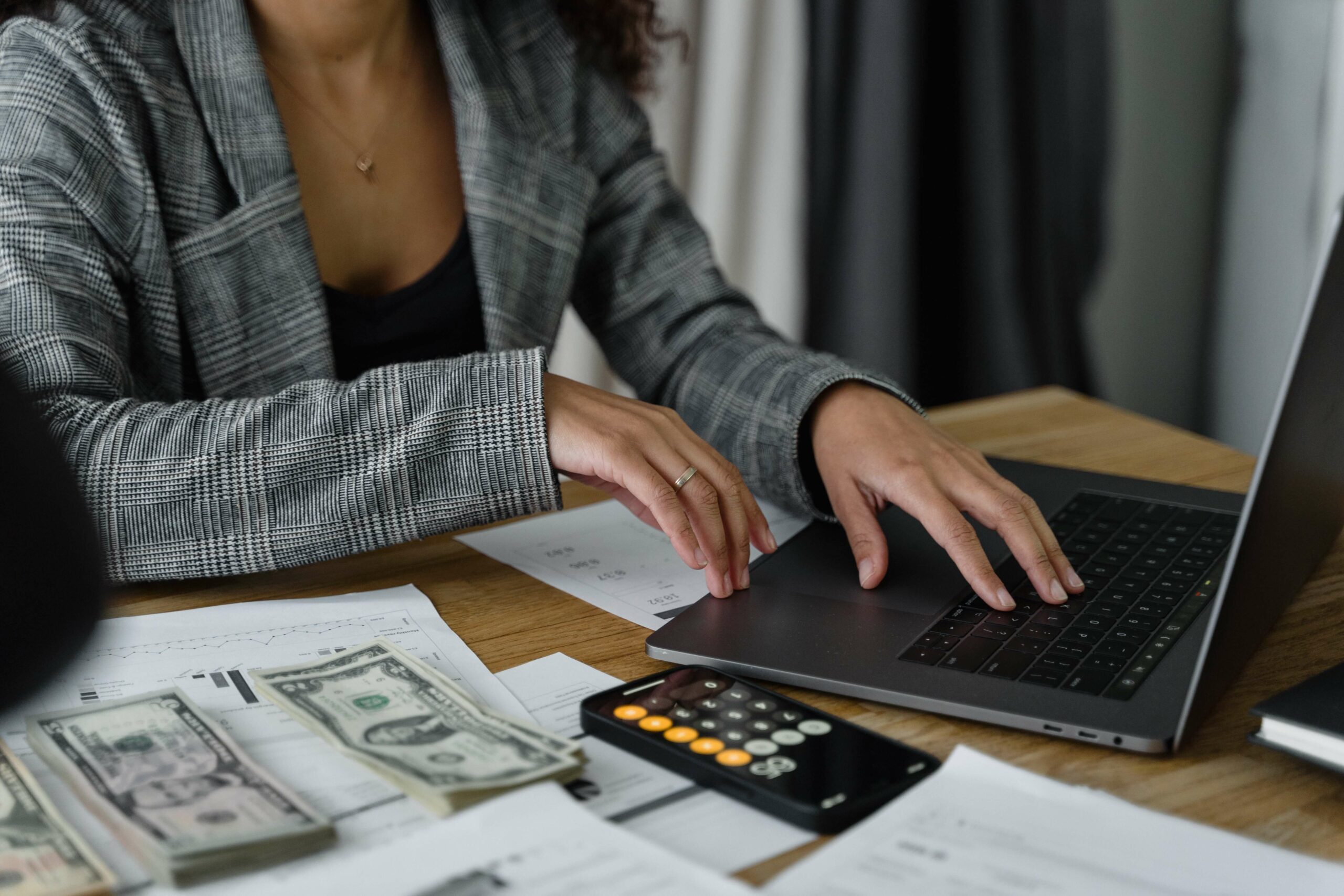 woman calculating costs on laptop