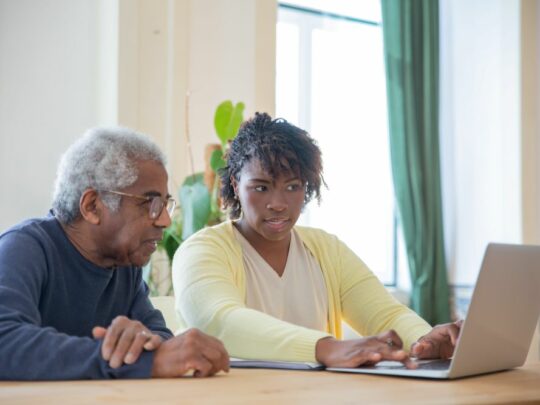 hospice nurse on laptop with patient