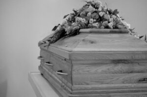 black and white funeral casket with flowers