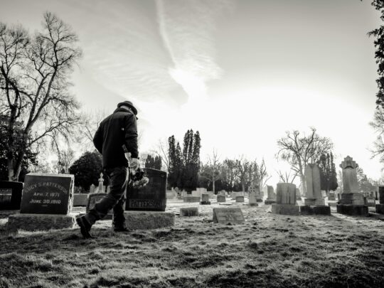 black and white photo of man in gravesite