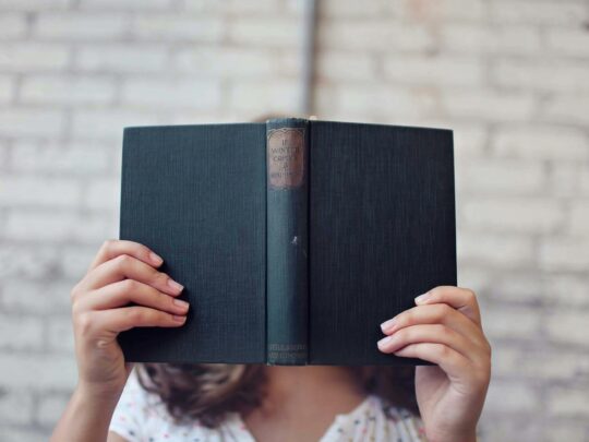woman reading dark book