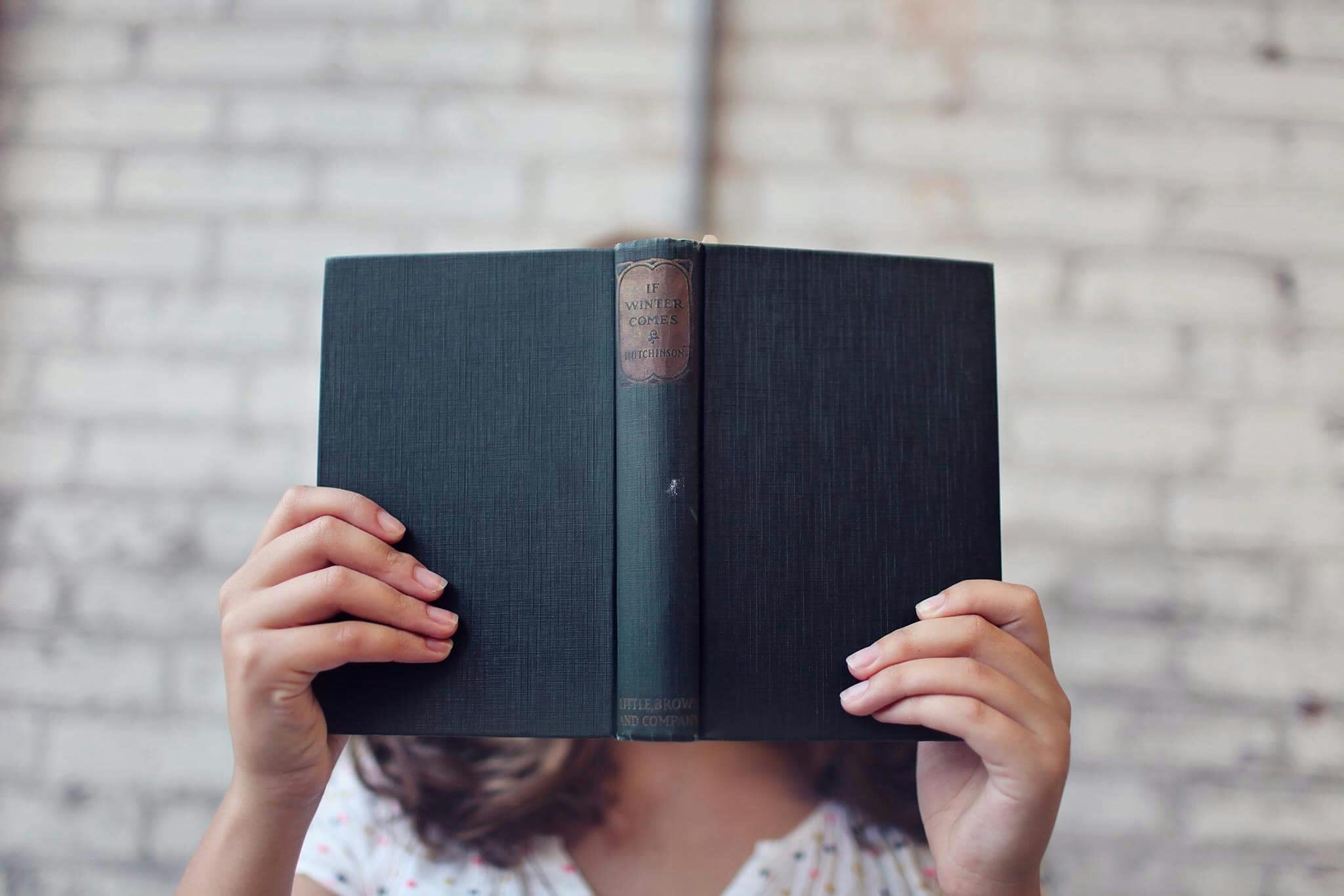 woman reading dark book